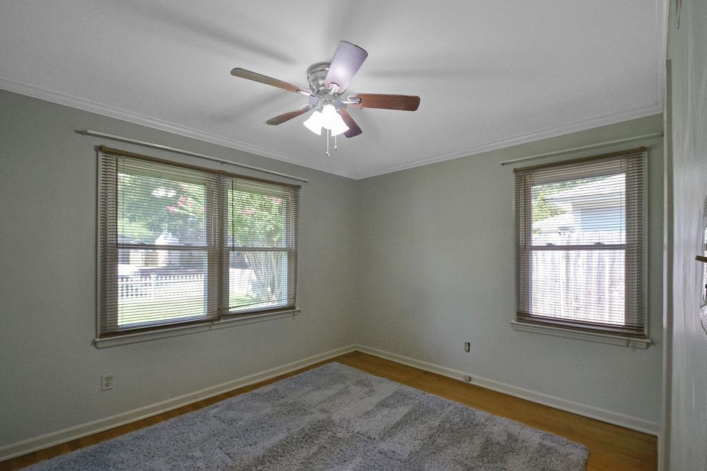 1514 Ivy Road Memphis, TN 38117 - Photo 20 of 30 a view of an empty room with chandelier fan and fire place