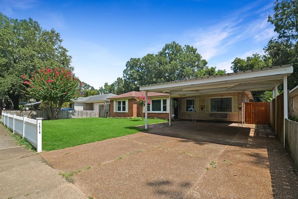 1514 Ivy Road Memphis, TN 38117 - Photo 2 of 30 a front view of a house with a garden