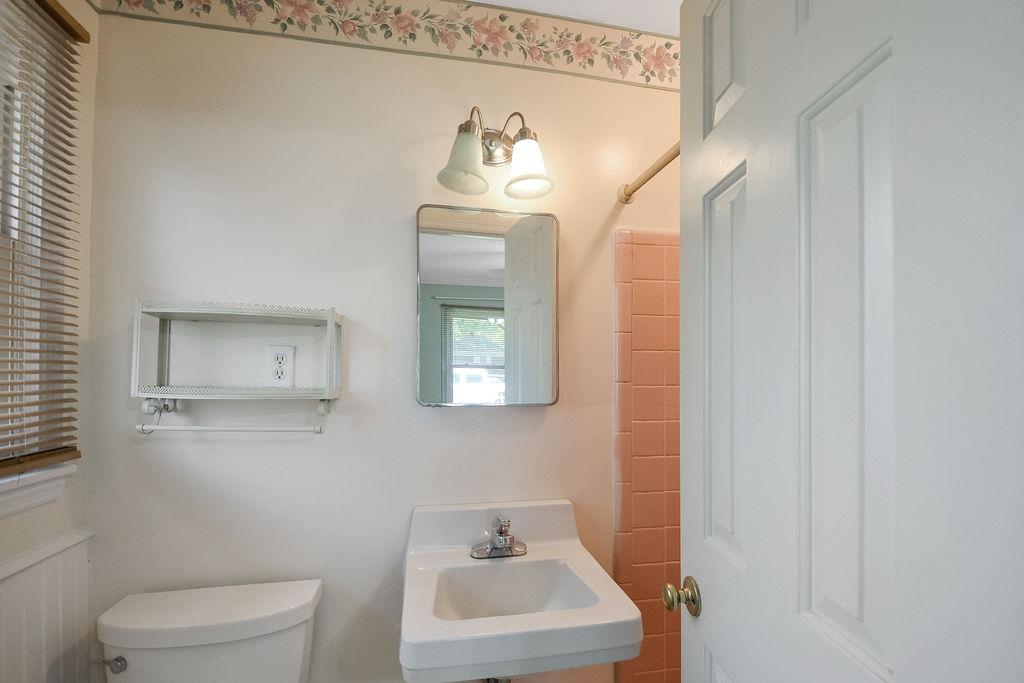 1514 Ivy Road Memphis, TN 38117 - Photo 23 of 30 a bathroom with a sink mirror and toilet