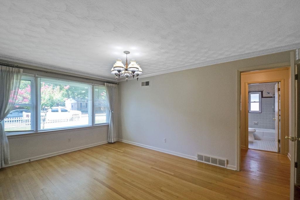 1514 Ivy Road Memphis, TN 38117 - Photo 6 of 30 a view of an empty room with wooden floor and a window
