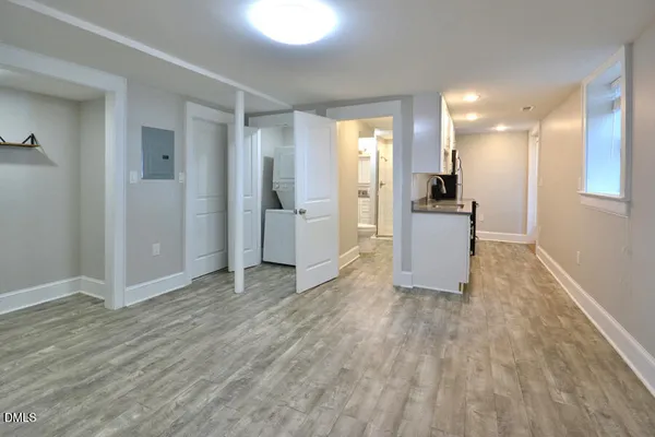 a view of empty room with wooden floor