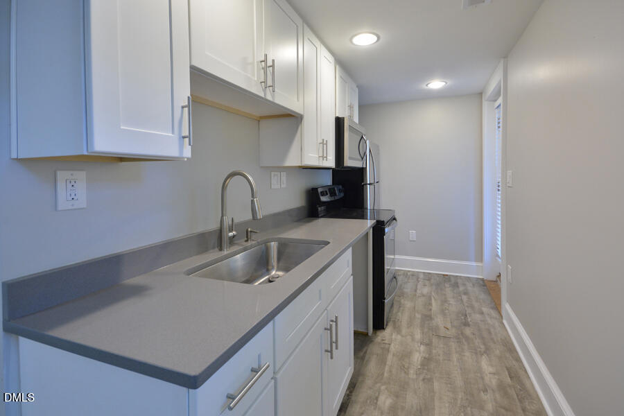 1900 Sunset Avenue Durham, NC 27705 - Photo 3 of 15 a kitchen with sink a microwave and cabinets