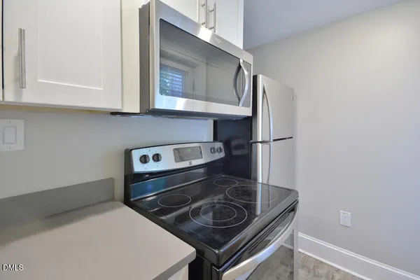 a kitchen with a stove microwave and sink