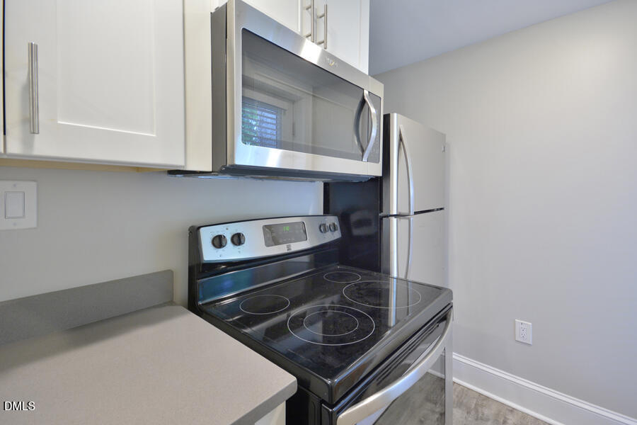 1900 Sunset Avenue Durham, NC 27705 - Photo 8 of 15 a kitchen with a stove and a microwave