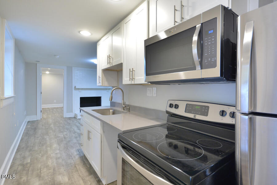 1900 Sunset Avenue Durham, NC 27705 - Photo 9 of 15 a kitchen with a stove microwave and sink