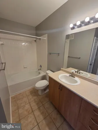 an empty room with windows and ceiling fan