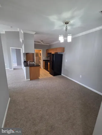 an empty room with a view of a livingroom