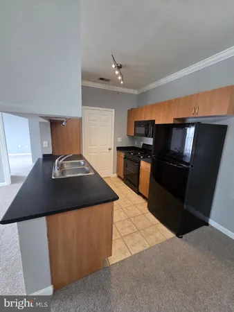 a kitchen with stainless steel appliances granite countertop a stove and a refrigerator