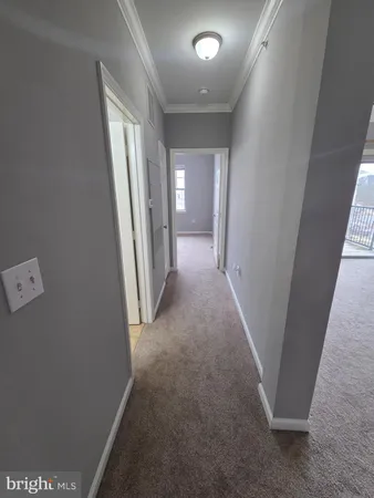 en empty room with windows and fireplace