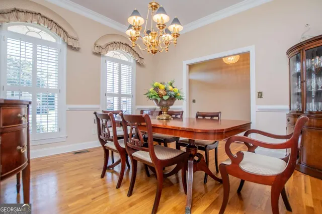 a dining room with furniture a livingroom and chandelier