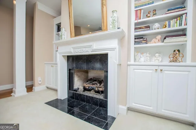 a hallway with a fireplace and a book shelf