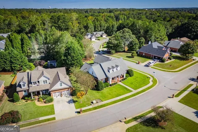 an aerial view of a house with a big yard
