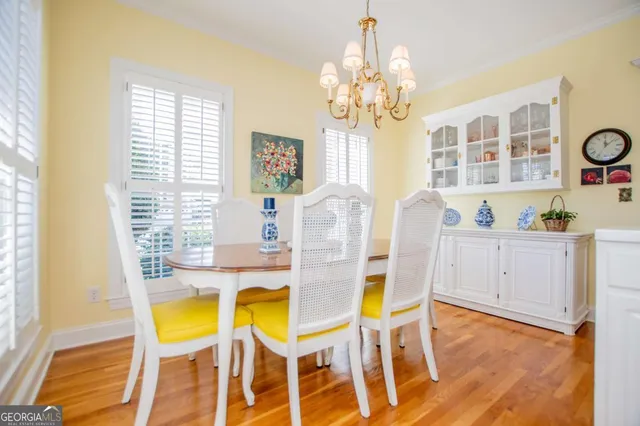 a view of a dining room with furniture and a chandelier