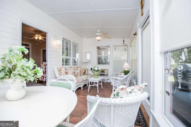 a living room with furniture potted plant and windows