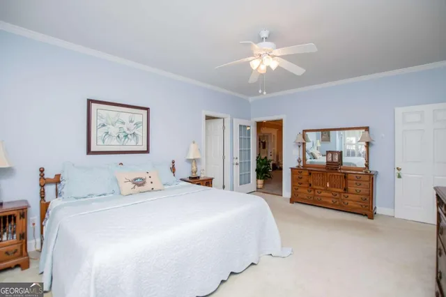 a spacious bedroom with a bed and a chandelier