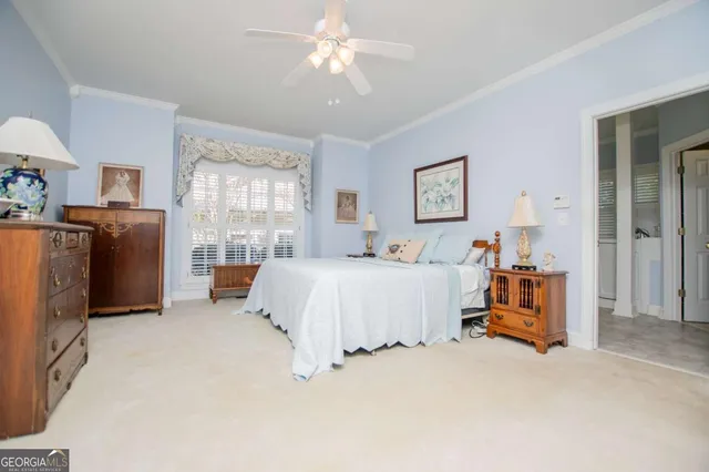 a bedroom with bed and a chandelier