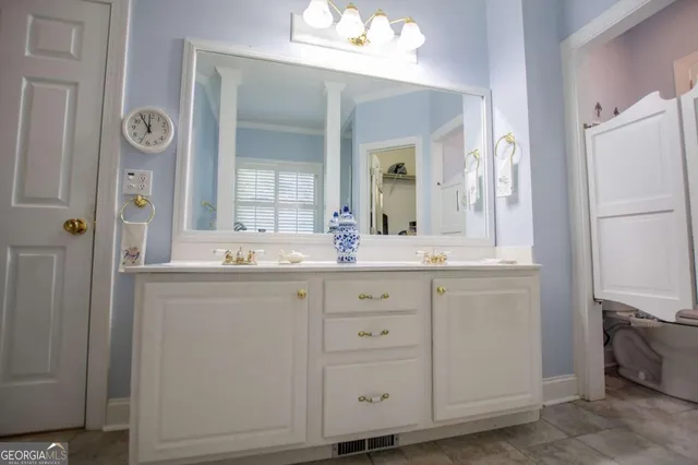 a bathroom with a double vanity sink and a mirror