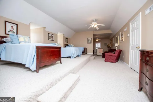 a living room with furniture and a lamp