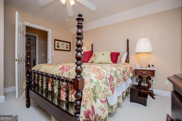 a bedroom with bed and a chandelier