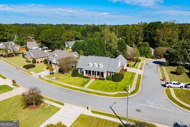 an aerial view of a house with a swimming pool