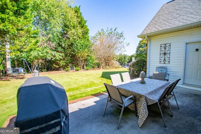 a view of a swimming pool with a table and chairs
