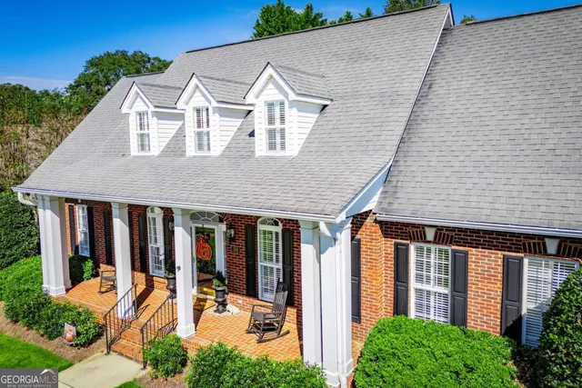 a front view of a house with glass windows and yard