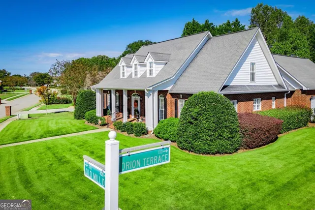 a aerial view of a house with yard and green space