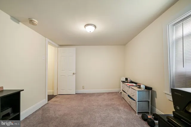 an empty room with closet and windows