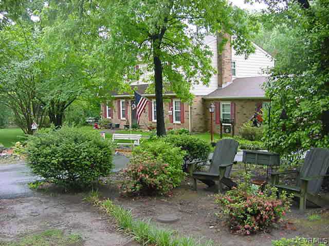 11000 Surry Road Chester, VA 23831 - Photo 2 of 10 a house view with a garden and outdoor seating