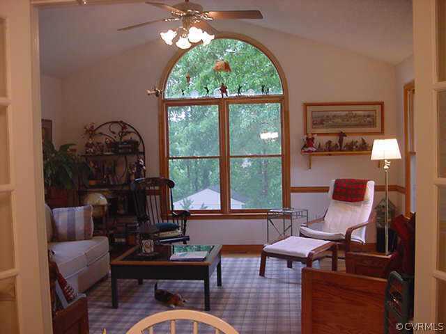 11000 Surry Road Chester, VA 23831 - Photo 6 of 10 a living room with furniture and a floor to ceiling window