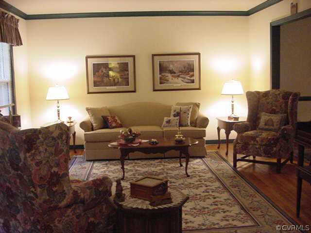 11000 Surry Road Chester, VA 23831 - Photo 7 of 10 a living room with furniture and a rug