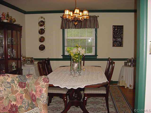 11000 Surry Road Chester, VA 23831 - Photo 8 of 10 a view of a dining room with furniture and chandelier