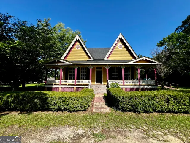 a front view of a house with swimming pool having outdoor seating