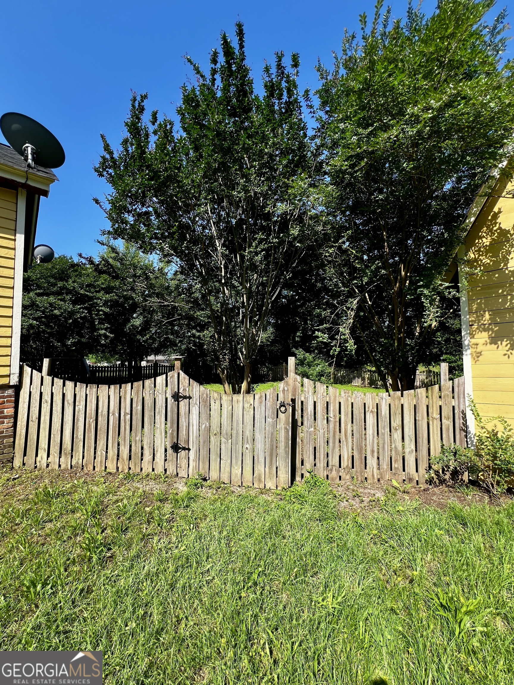 1311 3rd Street Dudley, GA 31022 - Photo 12 of 43 a view of a yard with wooden fence