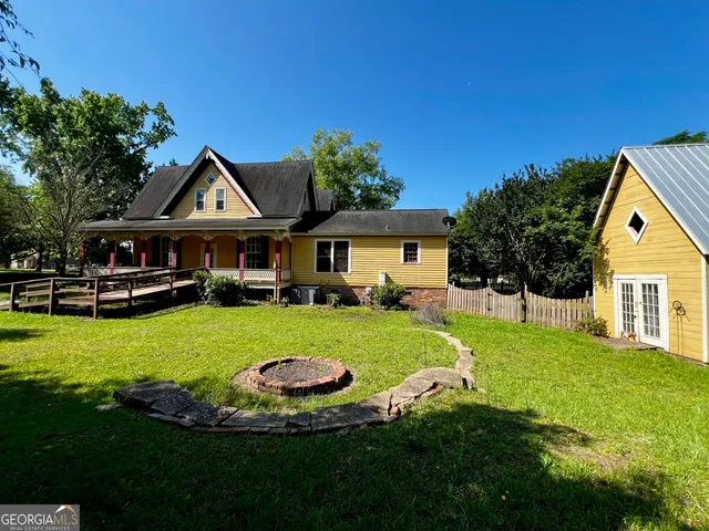 a front view of a house with a garden and swimming pool