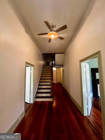 a view of entryway and hall with wooden floor