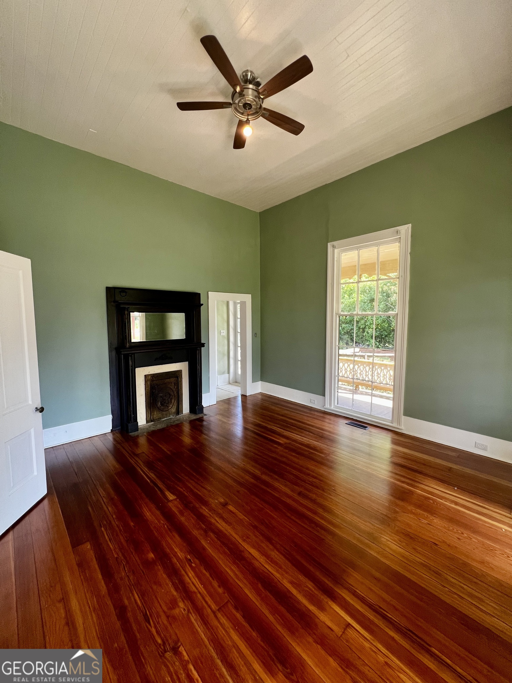 1311 3rd Street Dudley, GA 31022 - Photo 18 of 43 a living room with wooden floor and a fireplace