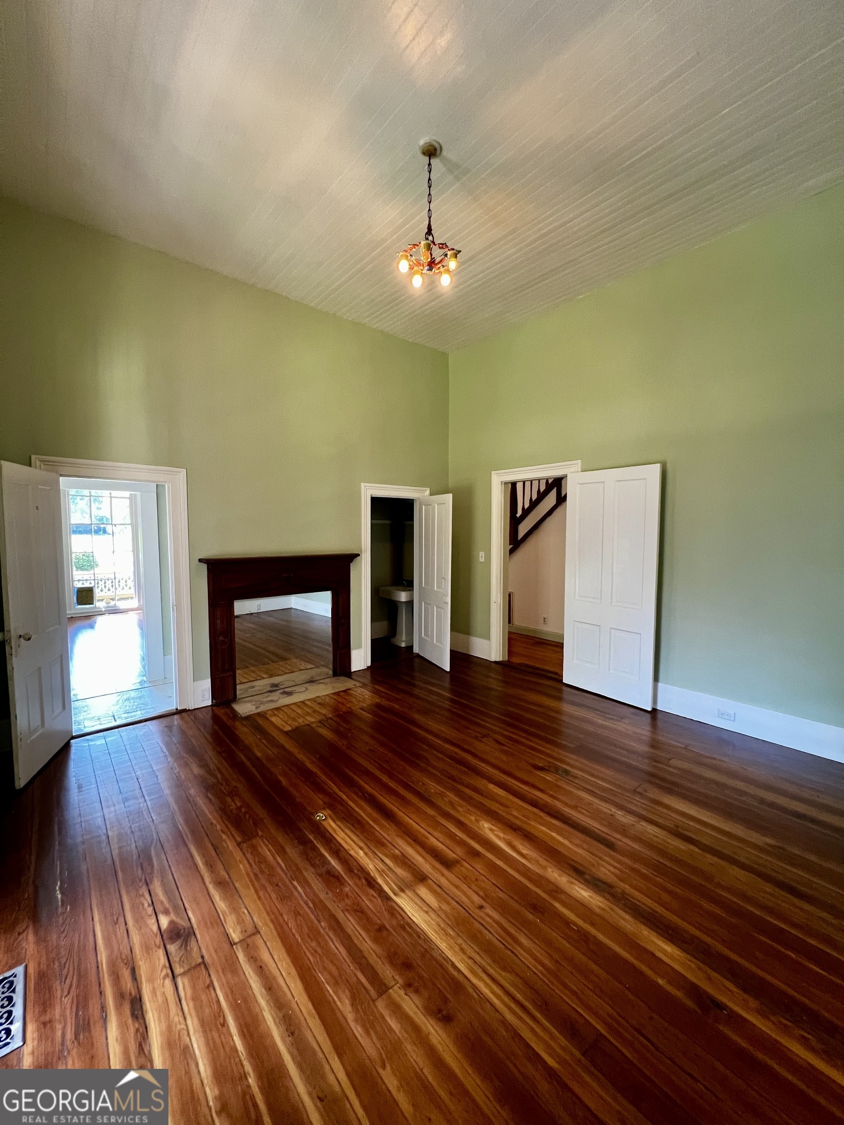 1311 3rd Street Dudley, GA 31022 - Photo 21 of 43 a view of an empty room with wooden floor and a fireplace
