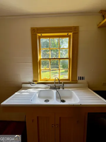 a bathroom with a sink and a window