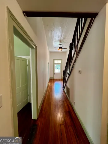 a view of stairs and wooden floor