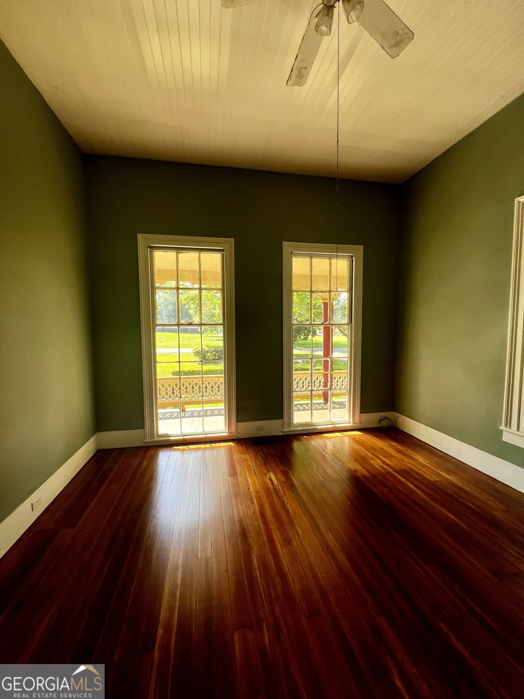 1311 3rd Street Dudley, GA 31022 - Photo 32 of 43 a view of an empty room with wooden floor and a window