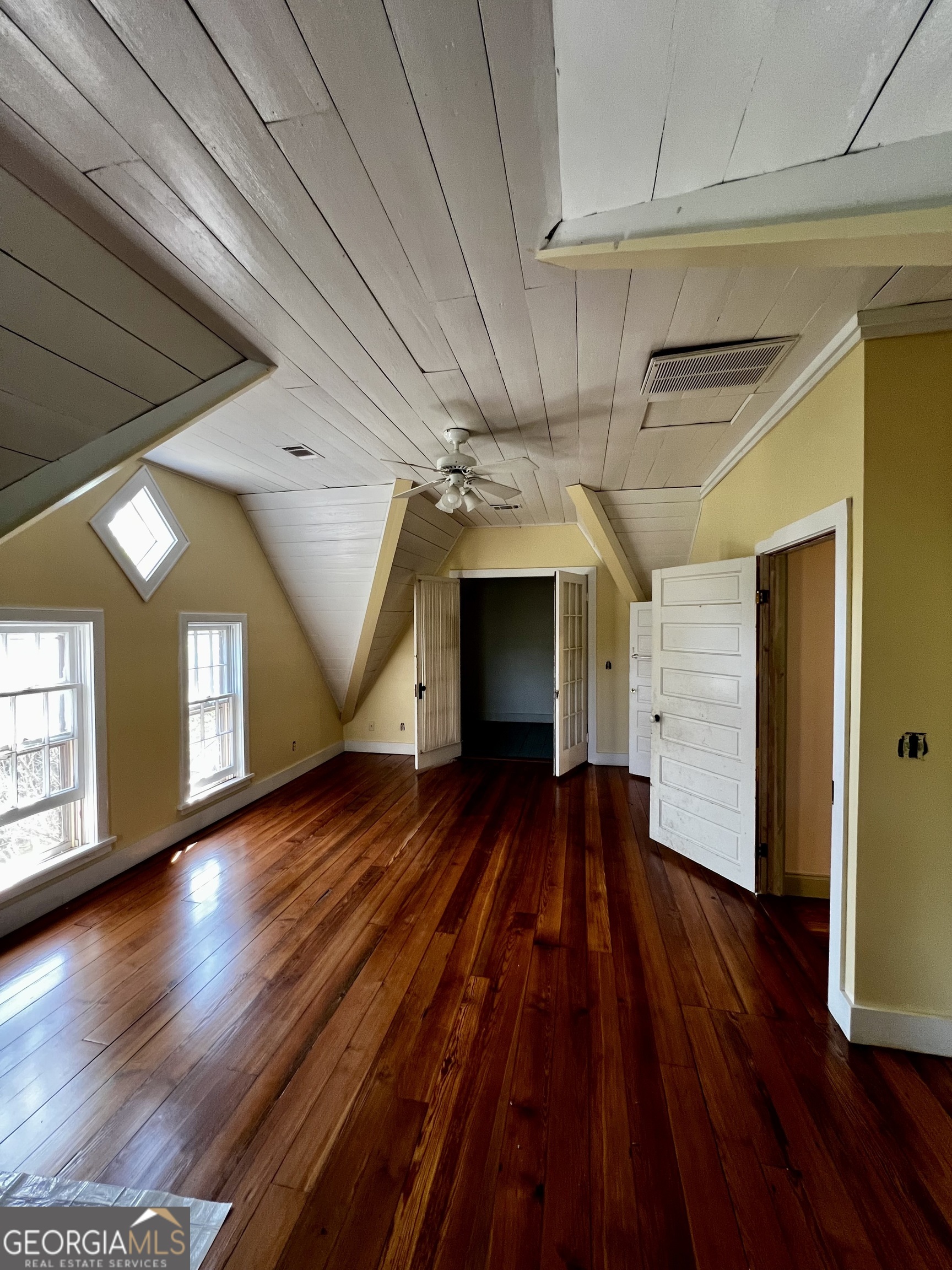 1311 3rd Street Dudley, GA 31022 - Photo 40 of 43 a view of an empty room with wooden floor and a window