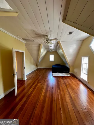 a view of a livingroom with wooden floor and a cabinet