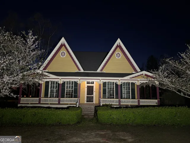 a front view of a house with a garden