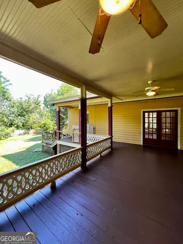 a view of a room with wooden floor and windows