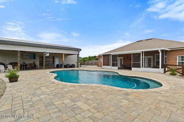 a view of a house with swimming pool and sitting area