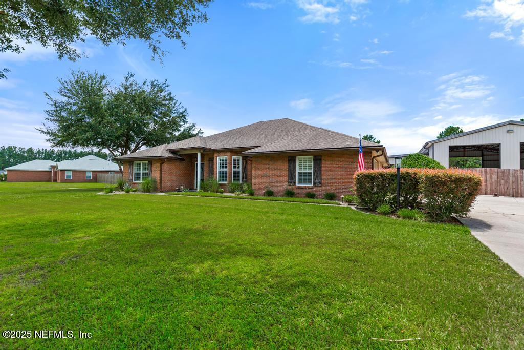 44677 Green Meadows Lane Callahan, FL 32011 - Photo 11 of 91 a front view of a house with a garden