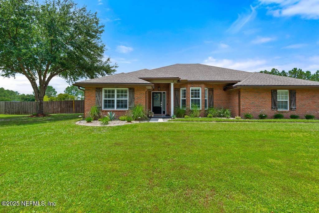 44677 Green Meadows Lane Callahan, FL 32011 - Photo 13 of 91 a front view of a house with a garden
