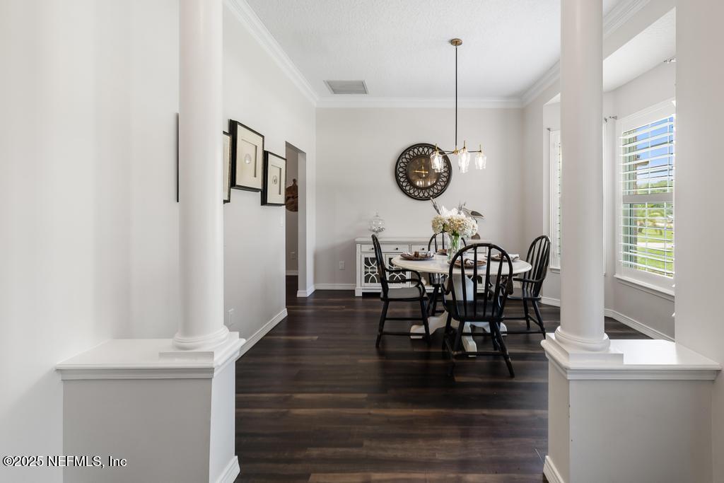44677 Green Meadows Lane Callahan, FL 32011 - Photo 17 of 91 a view of a dining room and livingroom with furniture wooden floor a rug a chandelier