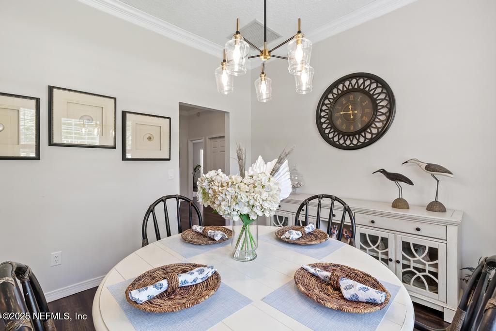 44677 Green Meadows Lane Callahan, FL 32011 - Photo 20 of 91 a table and a vase of flowers sitting on a dining table